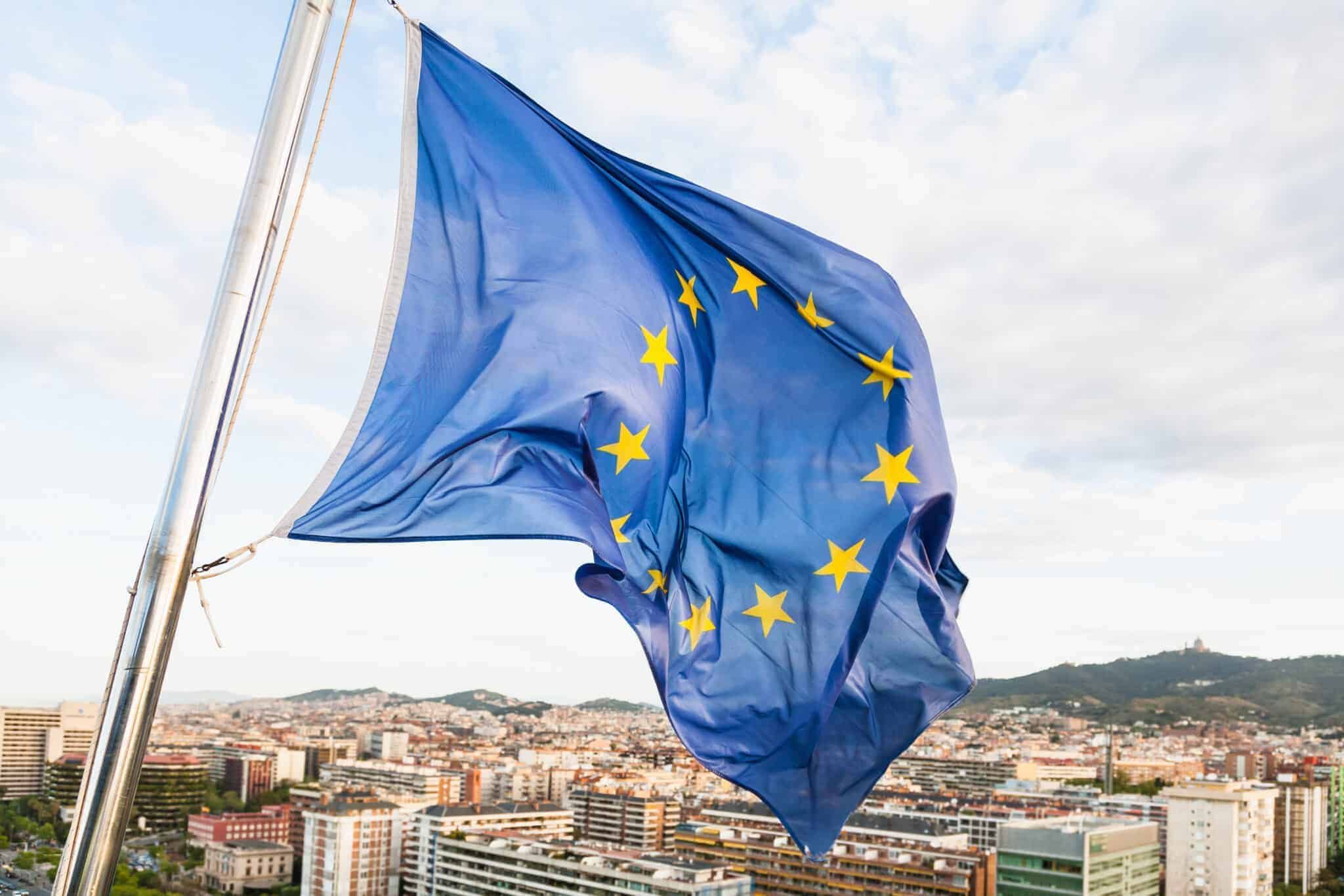 EU flag fluttering by wind above Barcelona